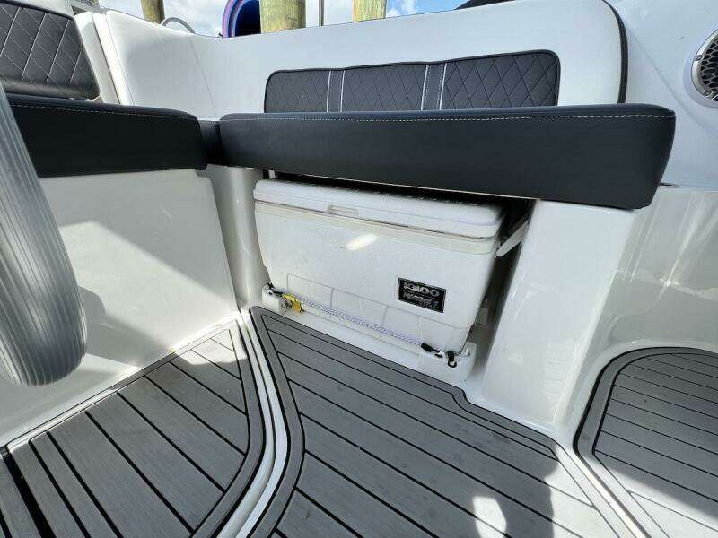 Interior of 2022 Monterey M-45 boat with built-in cooler and cushioned seating.
