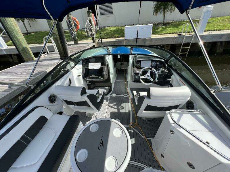 2022 Monterey M-45 boat interior with white seating, steering wheel, and table.