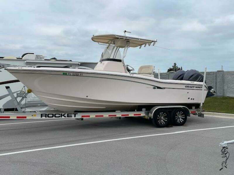 2014 Grady-White Fisherman 257 boat on Rocket trailer in parking lot.