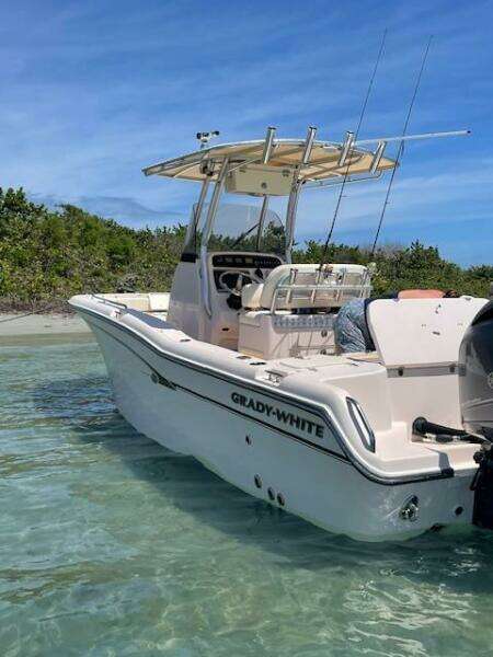 2014 Grady-White Fisherman 257 boat anchored in clear shallow water.