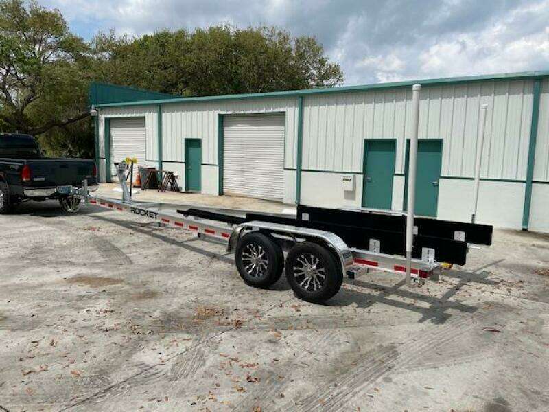 Boat trailer for 2014 Grady-White Fisherman 257 in front of storage units.