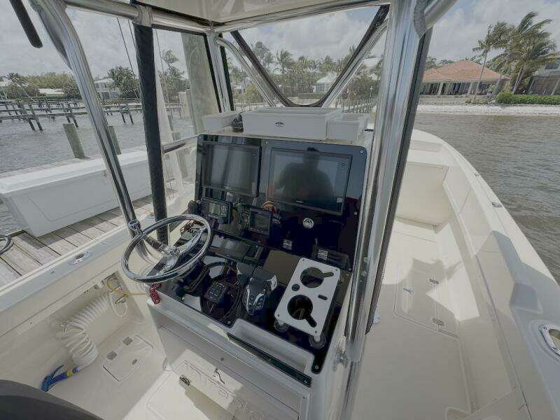 2004 Intrepid 32 Cuddy boat cockpit with steering wheel and navigation equipment.