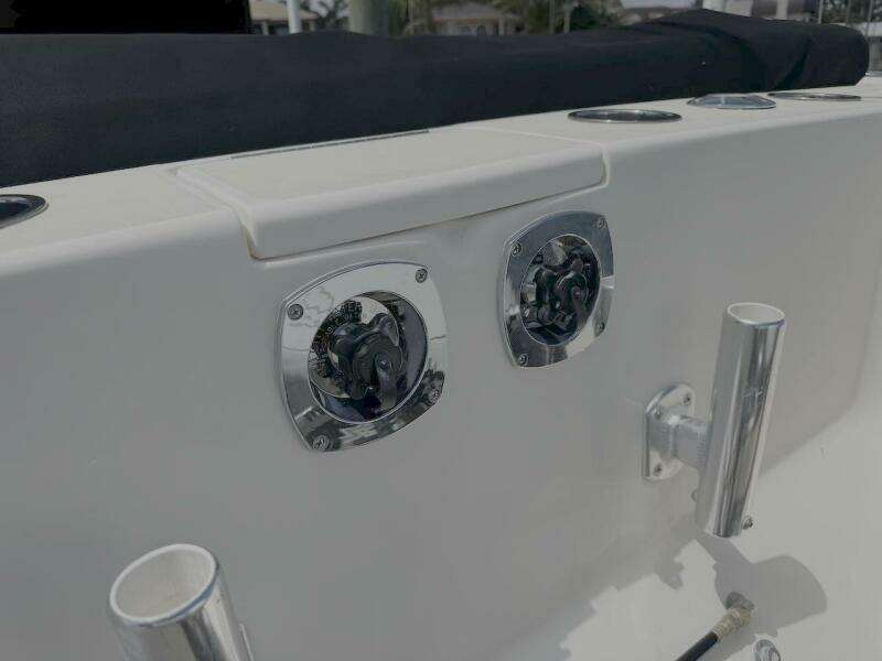 2004 Intrepid 32 Cuddy boat deck with chrome fittings and rod holders.