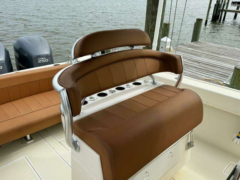 2004 Intrepid 32 Cuddy boat with brown leather seating and twin 250 engines.