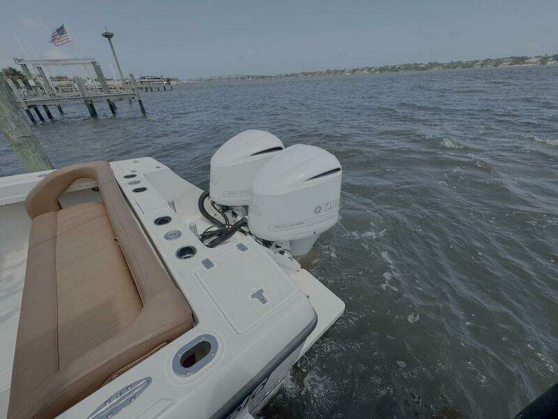 2004 Intrepid 32 Cuddy boat with twin outboard engines on the water.