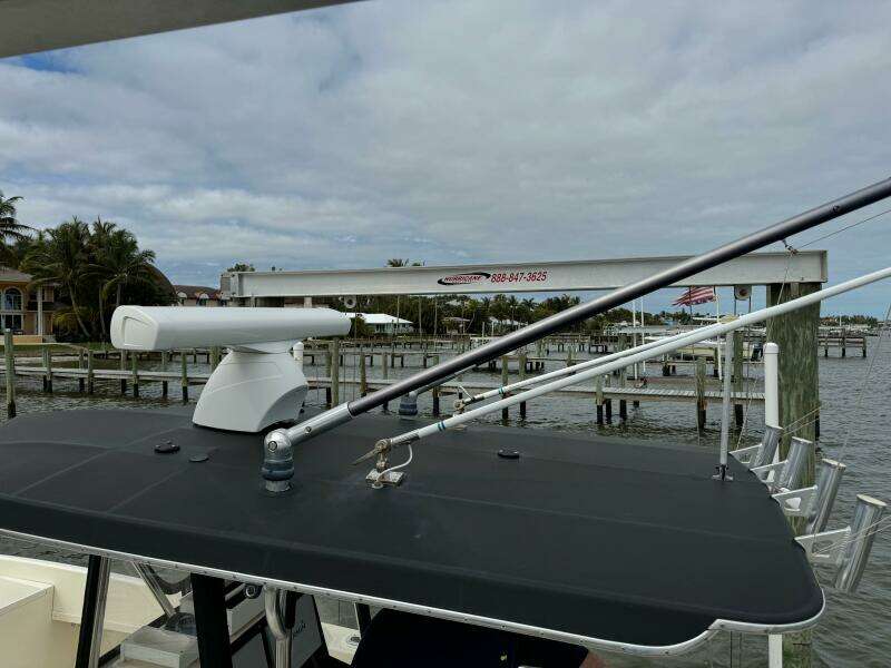 2004 Intrepid 32 Cuddy boat docked at a marina with radar equipment.