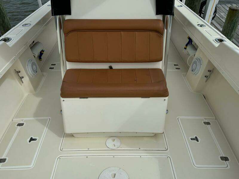 2004 Intrepid 32 Cuddy boat interior with tan seating and storage compartments.