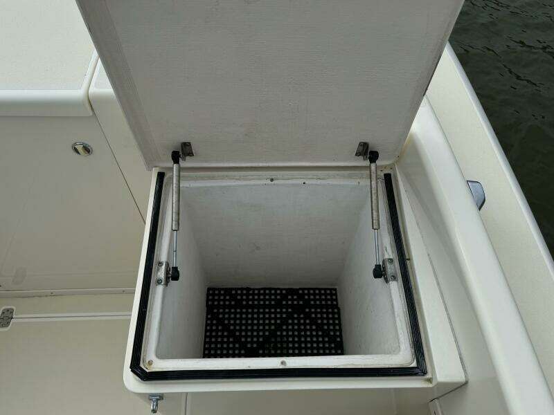 Open storage compartment on a 2004 Intrepid 32 Cuddy boat.
