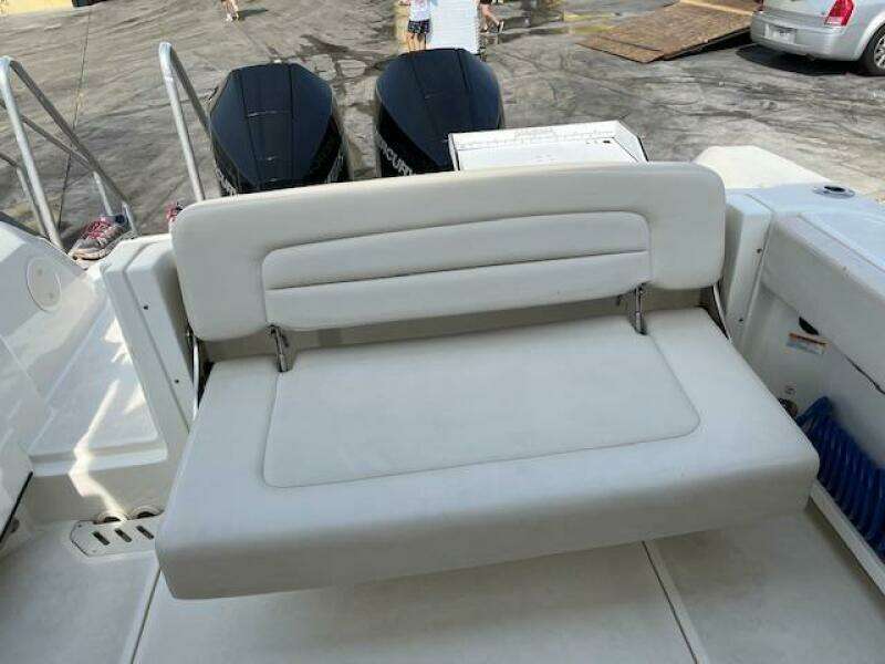 2018 Boston Whaler 270 Vantage boat with dual outboard engines and white cushioned seating.