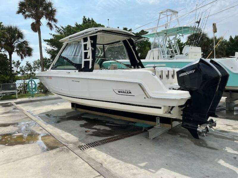 2018 Boston Whaler 270 Vantage boat on a dock with Mercury outboard engines.