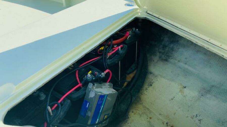Battery compartment of a 1983 Maverick 18 Flats Boat with wiring and connections.