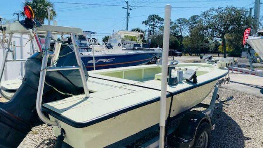 1983 Maverick 18 Flats Boat on a trailer in a boatyard.