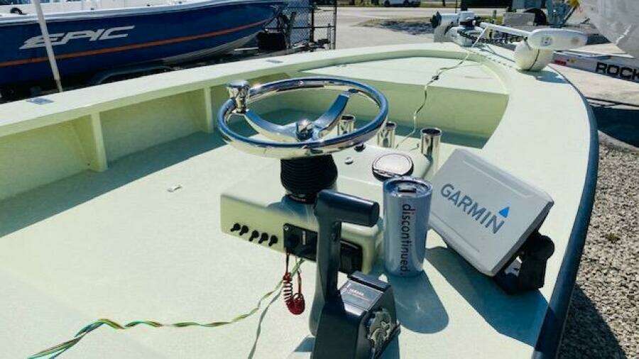 1983 Maverick 18 Flats Boat with Garmin navigation system and steering wheel.