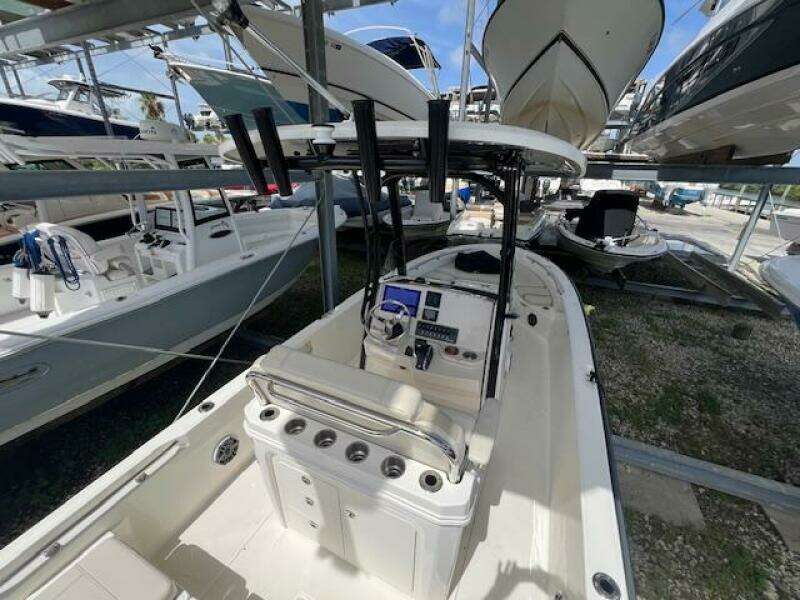 2023 Boston Whaler 250 Dauntless boat in storage, featuring a sleek console and seating area.