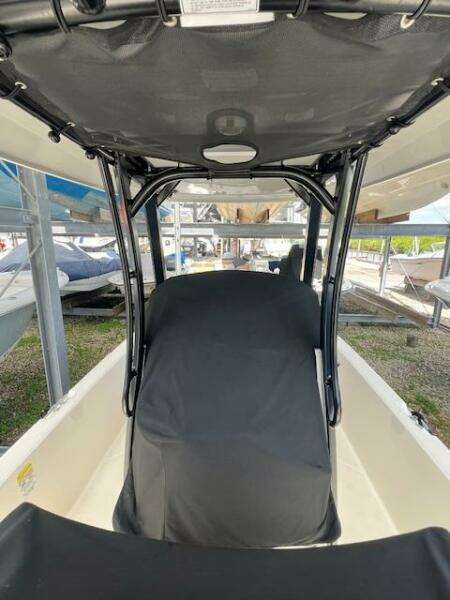 2023 Boston Whaler 250 Dauntless boat interior with covered seating and canopy.