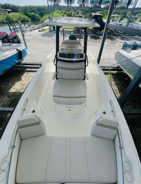 2023 Boston Whaler 250 Dauntless boat, sleek design, spacious seating, docked outdoors.
