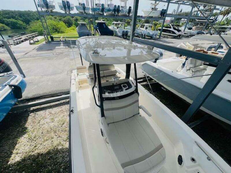 2023 Boston Whaler 250 Dauntless boat in storage, featuring sleek design and spacious deck.