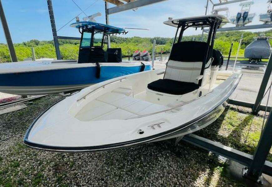 2023 Boston Whaler 250 Dauntless boat displayed outdoors on gravel.