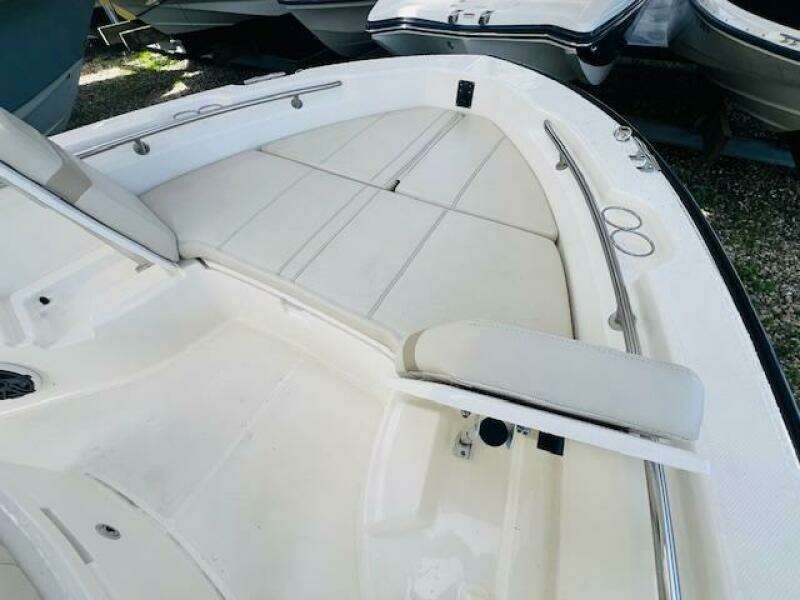 2023 Boston Whaler 250 Dauntless boat interior with cushioned seating and stainless steel railings.