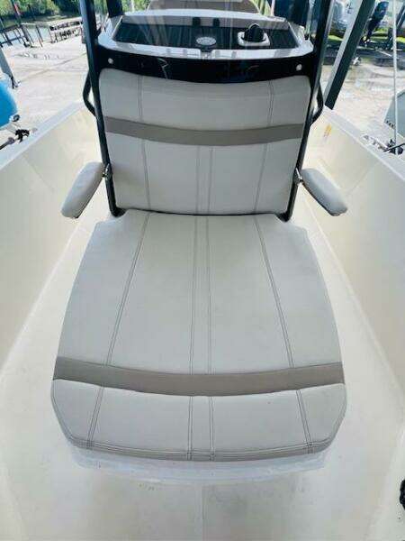 2023 Boston Whaler 250 Dauntless boat seat with armrests, white and gray upholstery.