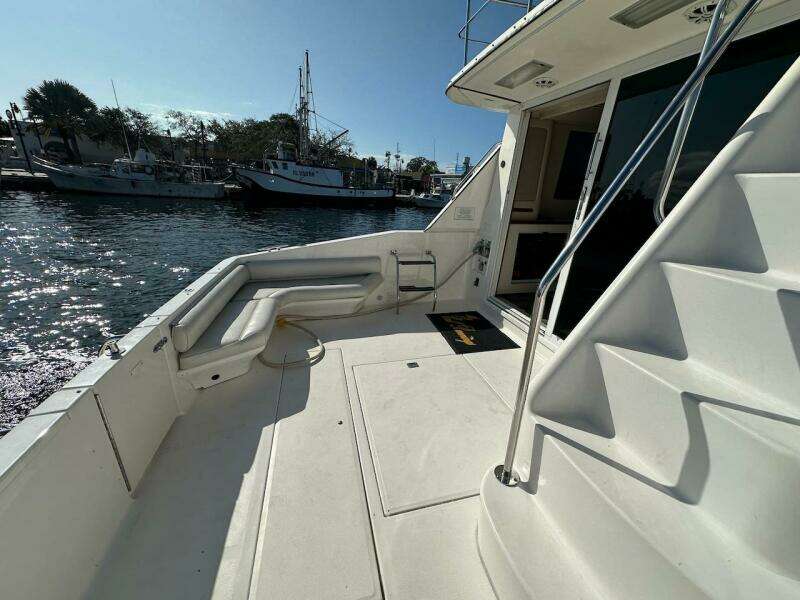 1997 Sea Ray 550 Sedan Bridge yacht deck with marina view.