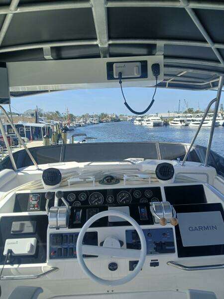 1997 Sea Ray 550 Sedan Bridge helm with Garmin navigation, docked at marina.