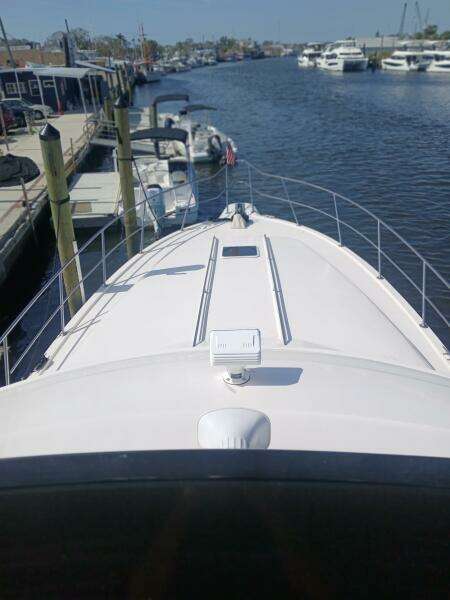1997 Sea Ray 550 Sedan Bridge yacht docked in a marina, view from the bow.