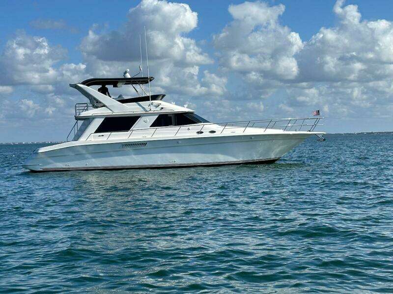 1997 Sea Ray 550 Sedan Bridge yacht cruising on open water.