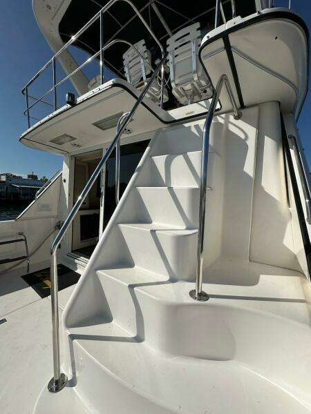 Staircase on a 1997 Sea Ray 550 Sedan Bridge yacht leading to the upper deck.