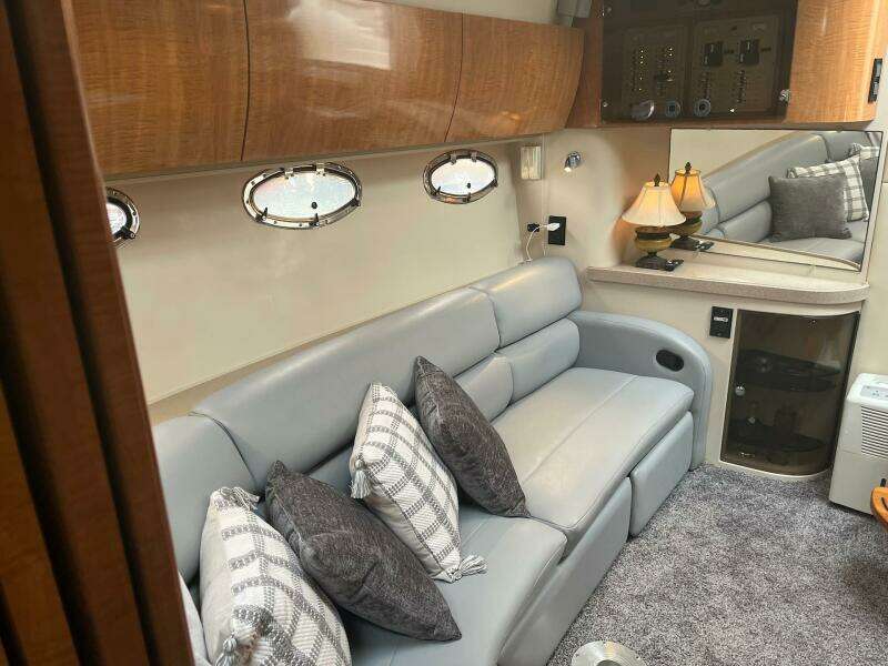 Luxurious interior of 2003 Regal Commodore 3860 yacht with plush seating and elegant decor.