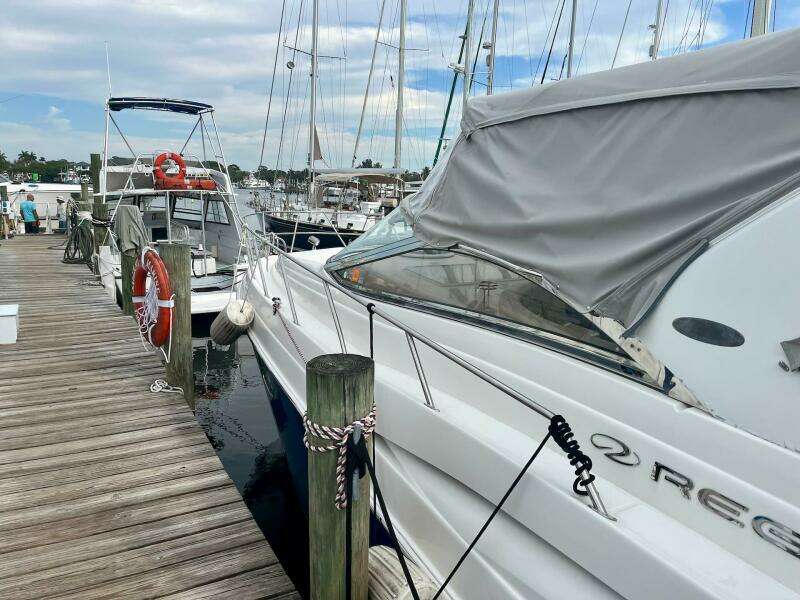 2003 Regal Commodore 3860 yacht docked at marina with protective cover.