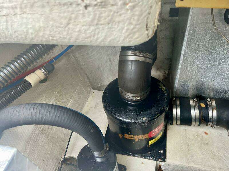 Engine compartment of a 2003 Regal Commodore 3860 boat showing hoses and fittings.