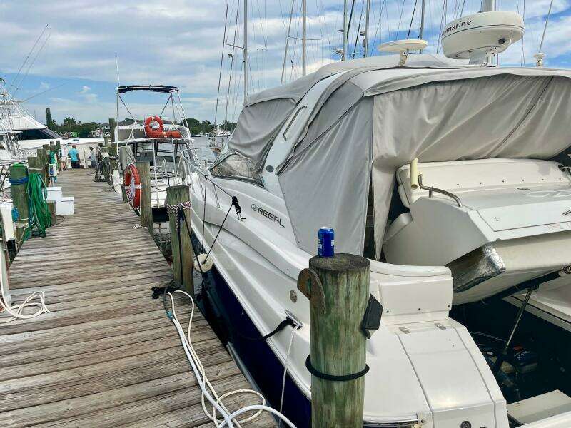 2003 Regal Commodore 3860 yacht docked at a marina with a covered deck.
