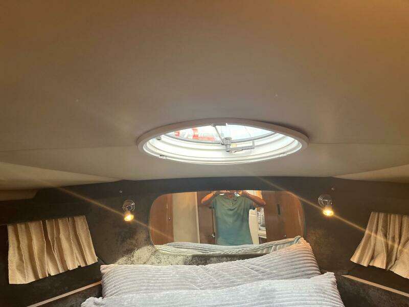 Interior cabin of 2003 Regal Commodore 3860 yacht with bed and porthole.