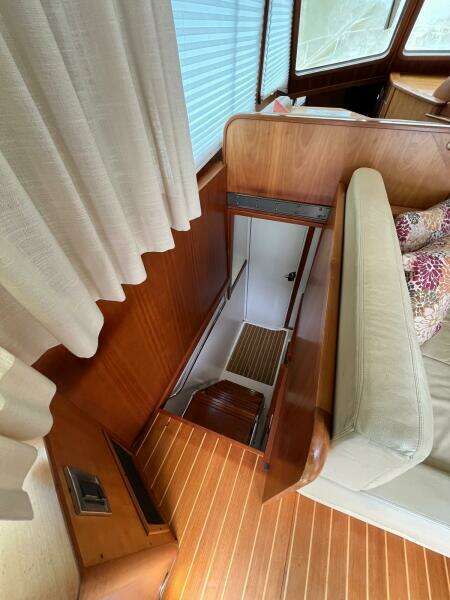 Interior of 2013 Sabre 48 Salon Express, featuring wooden stairs and seating area.