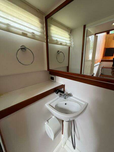 Compact bathroom in 2013 Sabre 48 Salon Express yacht with sink and mirror.