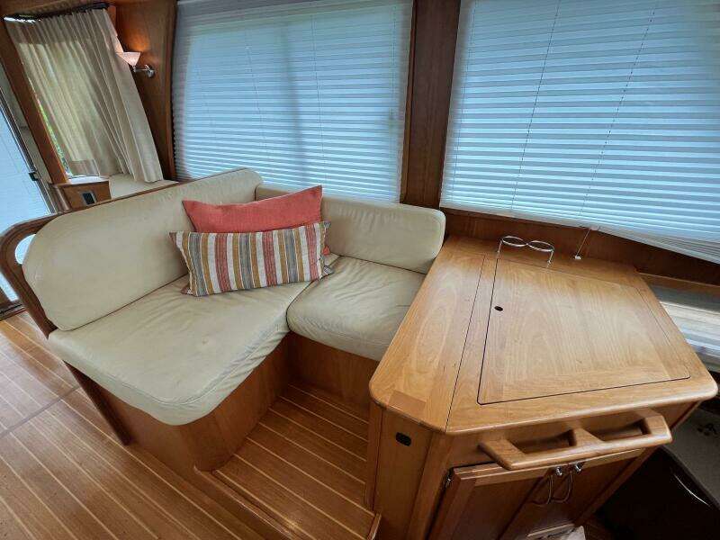 Interior of 2013 Sabre 48 Salon Express with cozy seating and wooden table.