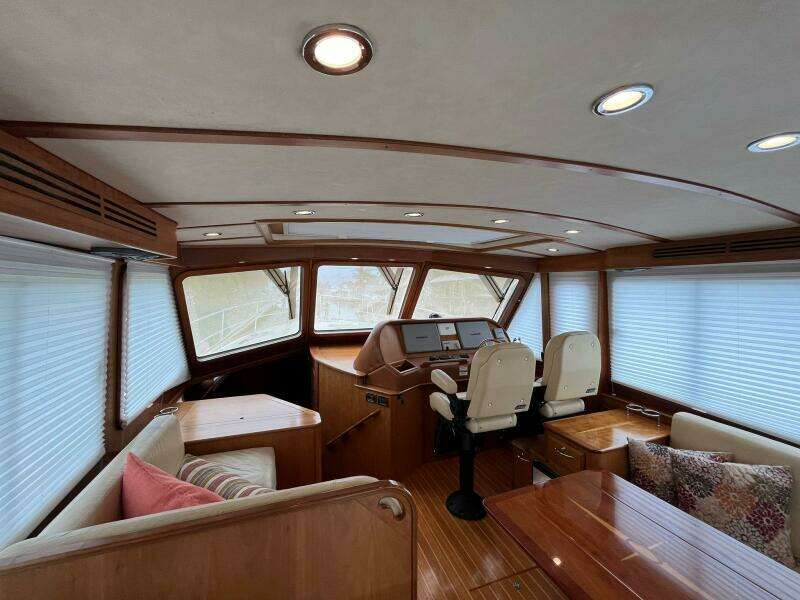 Interior of 2013 Sabre 48 Salon Express yacht with wood finish and plush seating.