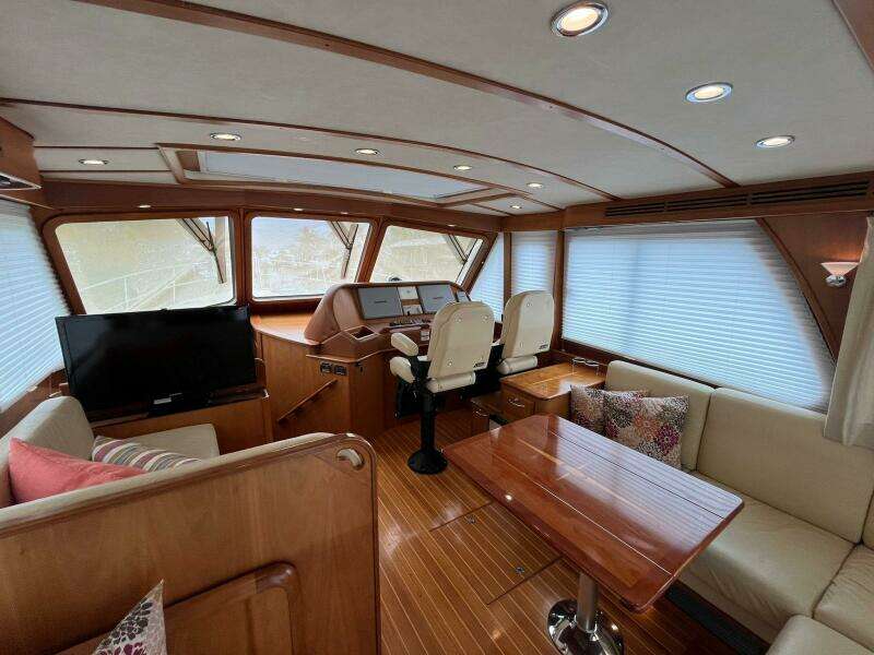 Interior of 2013 Sabre 48 Salon Express yacht with elegant wood finish and seating area.