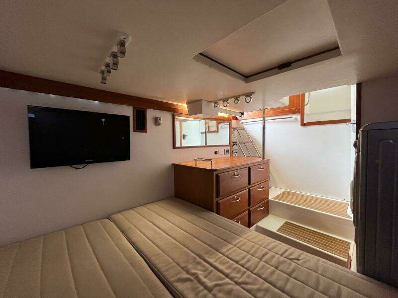 Interior of 2013 Sabre 48 Salon Express with bed, TV, and stairs.