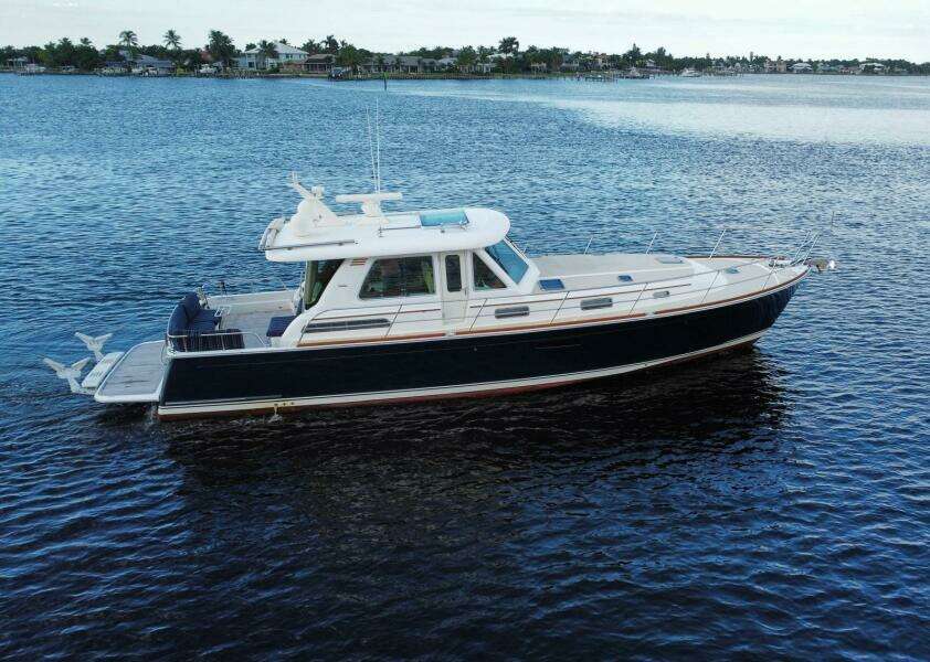 2013 Sabre 48 Salon Express yacht on calm water, side view.