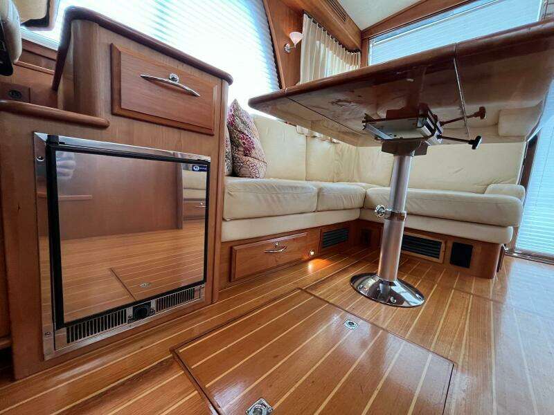 Interior of 2013 Sabre 48 Salon Express with wood flooring and seating area.