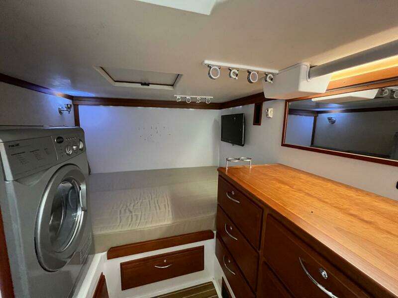 Interior of 2013 Sabre 48 Salon Express with bed, washer, and wooden cabinetry.