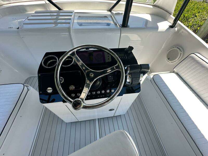 2000 Luhrs Tournament 320 Open boat helm with steering wheel and seating.