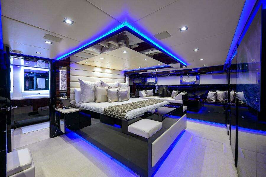 Luxurious master bedroom on a 1997 Broward 108 Raised Pilothouse yacht with modern LED lighting.