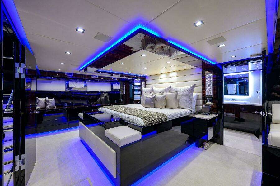Luxurious master bedroom on 1997 Broward 108 Raised Pilothouse yacht with modern LED lighting.