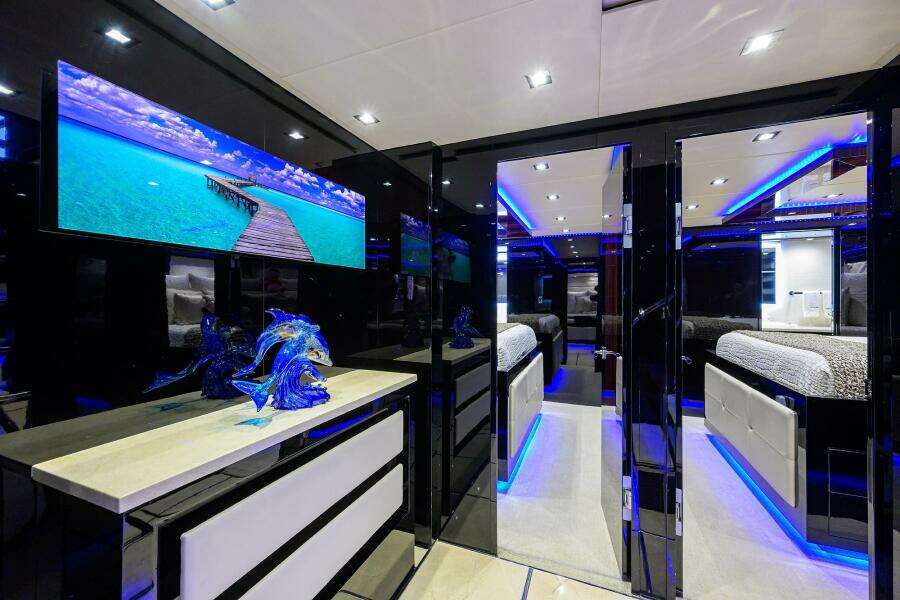 Luxurious interior of 1997 Broward 108 Raised Pilothouse yacht with modern decor and blue LED lighting.