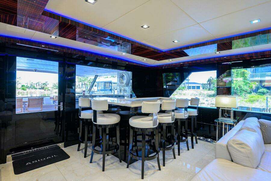 Luxurious interior of 1997 Broward 108 Raised Pilothouse yacht with modern bar area.