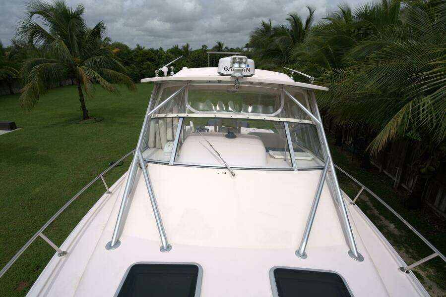 2007 Grady-White Express 330 boat with palm trees in the background.