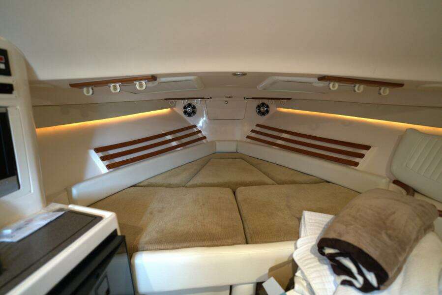 Interior cabin of 2007 Grady-White Express 330 boat with cozy seating and ambient lighting.